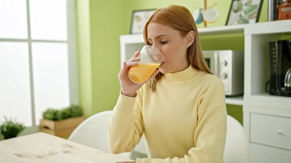 Young Blonde Woman Drinking Orange Juice Sitting Table Home — Stockfoto