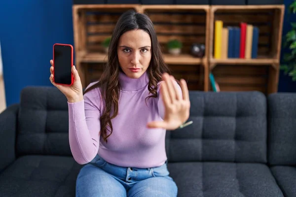 Jovem Morena Segurando Smartphone Mostrando Tela Branco Com Mão Aberta — Fotografia de Stock