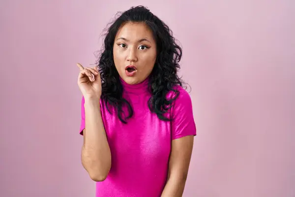 Jonge Aziatische Vrouw Staande Roze Achtergrond Verrast Wijzend Met Vinger — Stockfoto