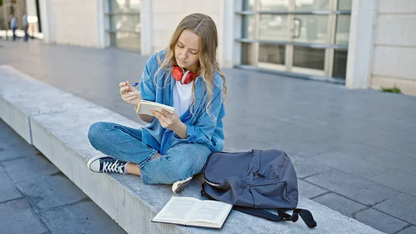 Young Blonde Woman Student Reading Book Writing Notebook University — Stock Photo, Image