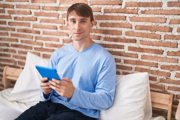 Young Caucasian Man Using Touchpad Sitting Bed Bedroom —  Fotos de Stock