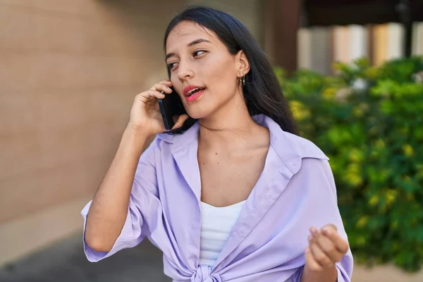 Young Beautiful Hispanic Woman Talking Smartphone Serious Expression Street — Stockfoto
