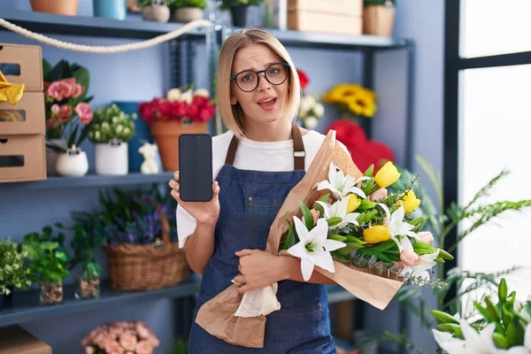Young Caucasian Woman Working Florist Shop Showing Smartphone Screen Clueless — Stock Photo, Image