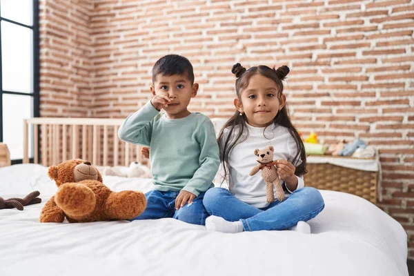 stock image Adorable boy and girl smiling confident holding teddy bear at bedroom