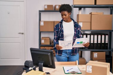 African american woman ecommerce business worker reading document at office