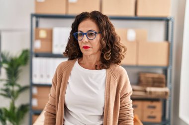 Middle age hispanic woman working at ecommerce