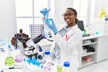 African american woman scientist holding test tube at laboratory