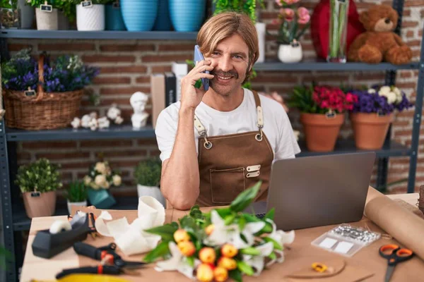 Young Blond Man Florist Talking Smartphone Using Laptop Flower Shop — Stock Photo, Image