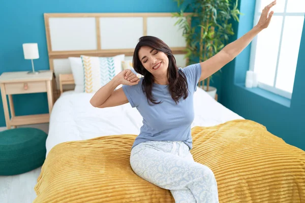 Middle Age Hispanic Woman Waking Stretching Arms Bedroom — Foto de Stock