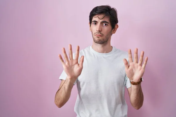 Young Hispanic Man Standing Pink Background Moving Away Hands Palms — Stok fotoğraf