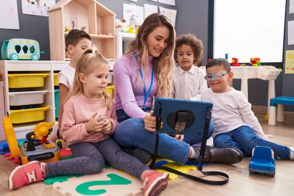 stock image Woman and group of kids having lesson using touchpad at kindergarten