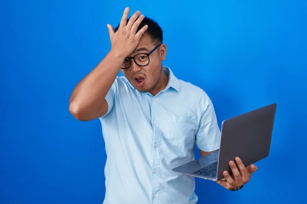 中国の若い男がコンピュータのラップトップを使用して頭の上に手を誤って エラーを覚えて驚いている 忘れられた悪い記憶の概念 — ストック写真