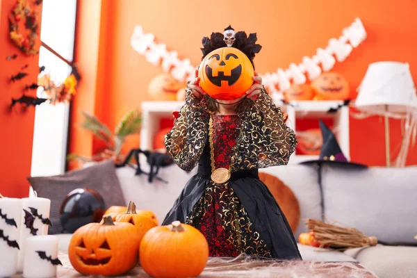 Adorable Hispanic Girl Wearing Halloween Costume Covering Face Pumpkin Basket — Stock Photo, Image