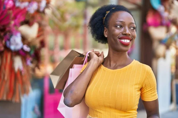 African American Woman Smiling Confident Holding Shopping Bags Street — Stockfoto