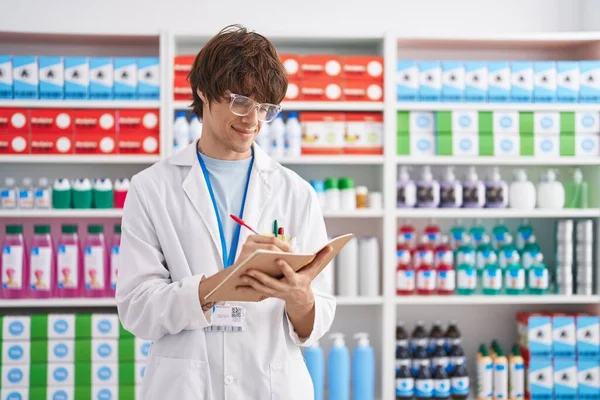 Young Blond Man Pharmacist Writing Notebook Pharmacy — Stock Photo, Image