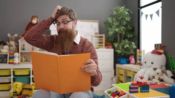 Young Redhead Man Preschool Teacher Reading Book Sitting Chair Kindergarten — Stockfoto