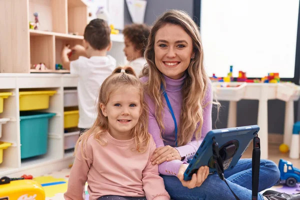 stock image Woman and group of kids having lesson using touchpad at kindergarten