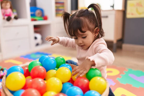 Adorable Hispanic Girl Playing Balls Sitting Floor Kindergarten — Foto de Stock