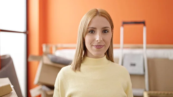 Stock image Young blonde woman smiling confident standing at new home