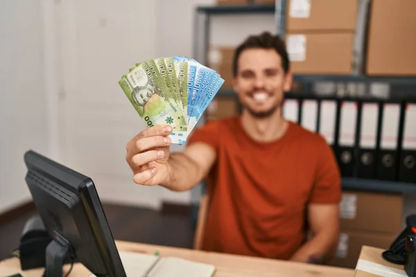 Young Hispanic Man Ecommerce Business Worker Holding Chile Pesos Banknotes — Stock Fotó