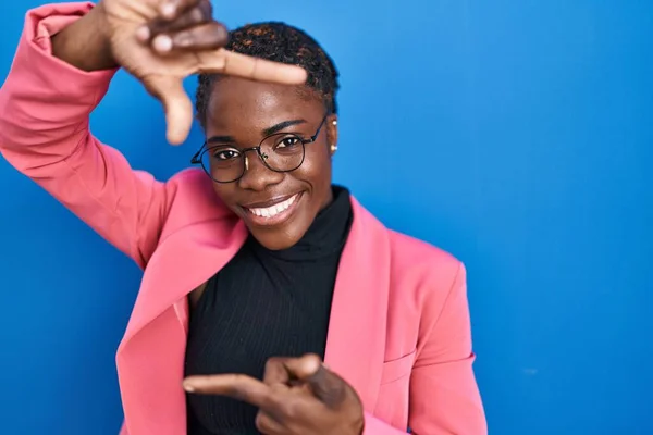Beautiful Black Woman Standing Blue Background Smiling Making Frame Hands — Fotografia de Stock