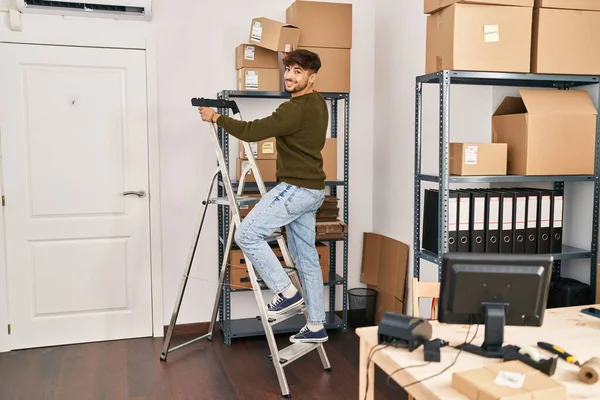 Young Arab Man Ecommerce Business Worker Holding Package Standing Ladder — Stock Photo, Image