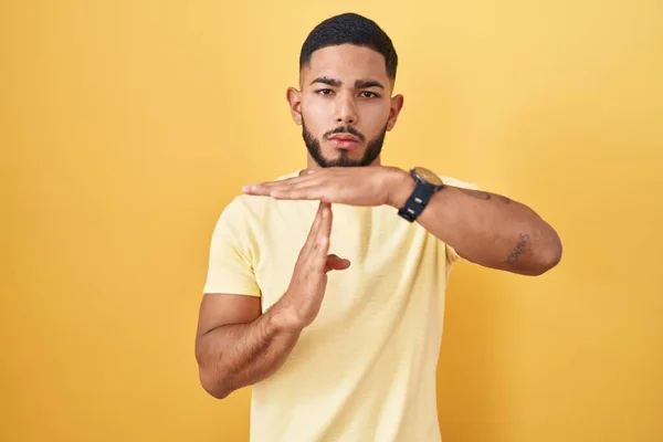 Young Hispanic Man Standing Yellow Background Doing Time Out Gesture — Stock Photo, Image