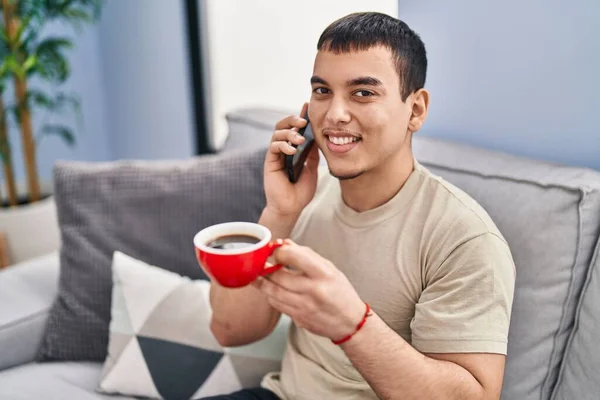 Young Man Drinking Coffee Talking Smartphone Home —  Fotos de Stock