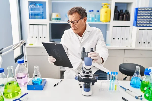 Middle Age Man Wearing Scientist Uniform Using Microscope Laboratory — Zdjęcie stockowe