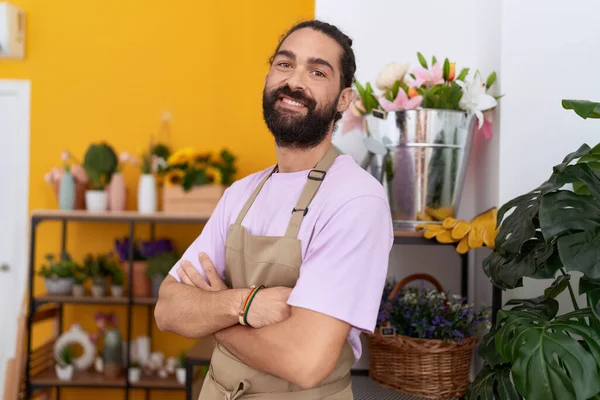 stock image Young hispanic man florist smiling confident standing with arms crossed gesture at flower shop