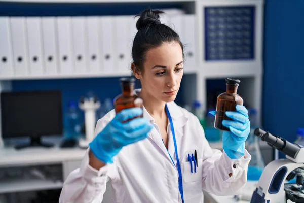 Young Caucasian Woman Scientist Holding Bottles Laboratory — ストック写真