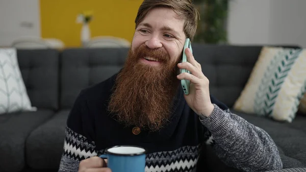 Young Redhead Man Talking Smartphone Drinking Coffee Home — Foto Stock