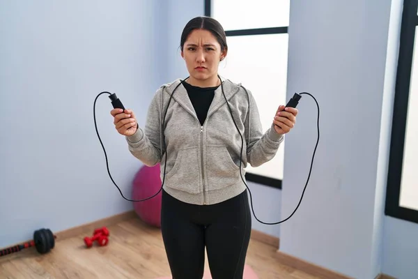 Young Latin Woman Jumping Skipping Rope Clueless Confused Expression Doubt — Stock Photo, Image