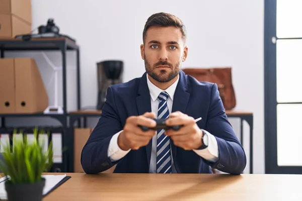 Handsome Hispanic Man Playing Video Games Office Relaxed Serious Expression — Stock Photo, Image