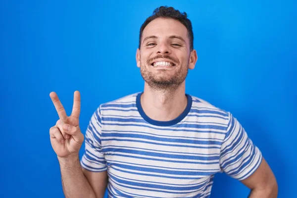 Young Hispanic Man Standing Blue Background Smiling Looking Camera Showing — Foto Stock