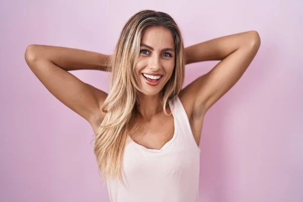 Young Blonde Woman Standing Pink Background Relaxing Stretching Arms Hands — Stock fotografie