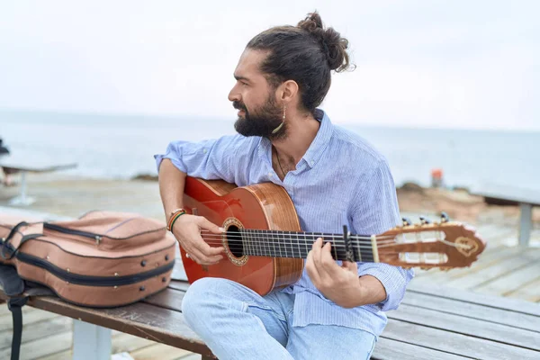 Young Hispanic Man Musician Playing Classical Guitar Sitting Bench Seaside — Stockfoto