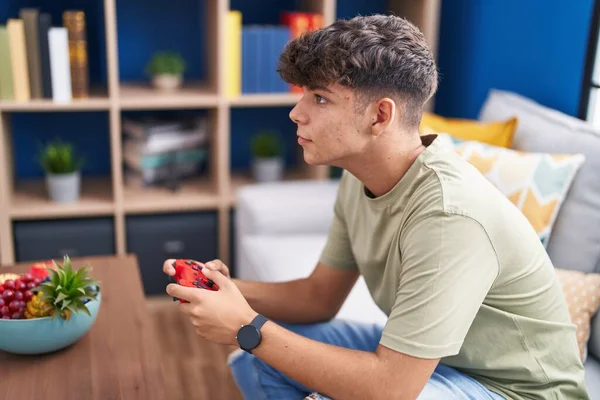 Young Hispanic Teenager Playing Video Game Sitting Sofa Home — Stockfoto