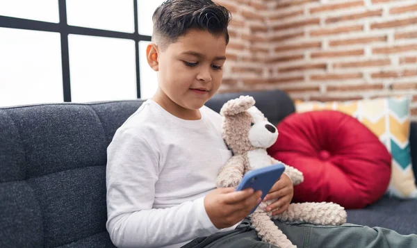Adorable Hispanic Boy Using Smartphone Sitting Sofa Home — Stockfoto