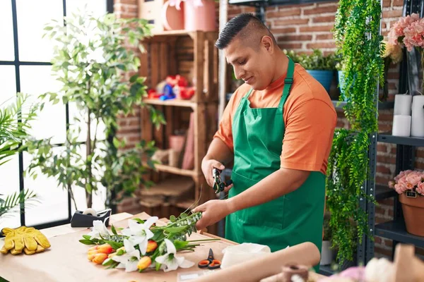 stock image Young latin man florist cutting stem at flower shop