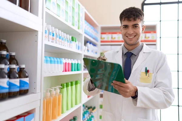 Young Hispanic Man Pharmacist Smiling Confident Writing Clipboard Pharmacy — Stock Photo, Image