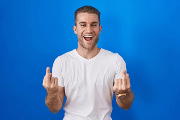 Young Caucasian Man Standing Blue Background Showing Middle Finger Doing — стоковое фото