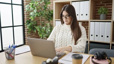 Young beautiful hispanic woman business worker using laptop working at office