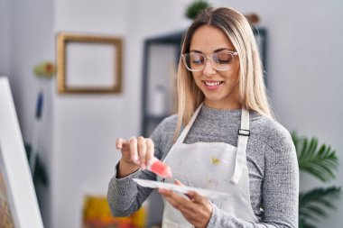 Young woman artist smiling confident drawing at art studio