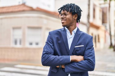 African american man executive smiling confident standing with arms crossed gesture at street