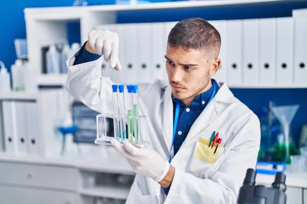 Young Hispanic Man Scientist Holding Test Tubes Laboratory — ストック写真