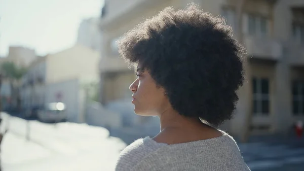 アフリカ系アメリカ人女性が通りで真剣な表情で横に目を向ける — ストック写真
