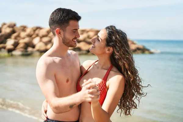 Young Hispanic Couple Tourists Wearing Swimsuit Dancing Seaside — Stok fotoğraf