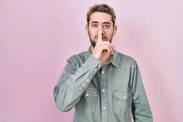 Hispanic Man Beard Standing Pink Background Asking Quiet Finger Lips — 스톡 사진