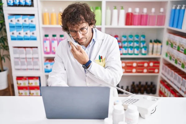 Young Hispanic Man Pharmacist Talking Telephone Using Laptop Pharmacy — Stock Photo, Image